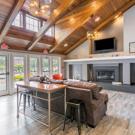 Cozy lounge with wood beams and modern decor at Runaway Bay in Lansing, Michigan