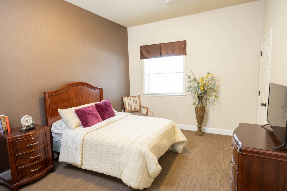 Bedroom with green accent wall at The Heritage of CyFair in Houston, Texas