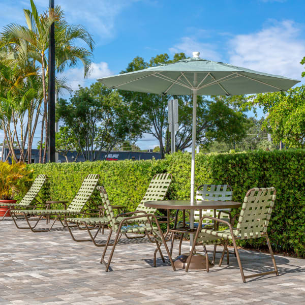 Lounge chairs on the pool deck at Forest Place Apartments in North Miami, Florida