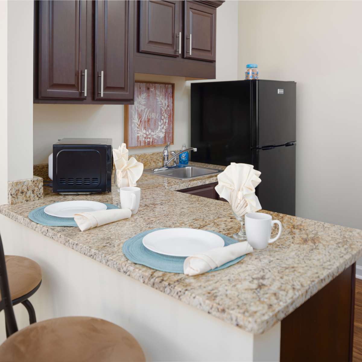 Kitchen with island and granite countertops at Harmony at Spring Hill in Lorton, Virginia