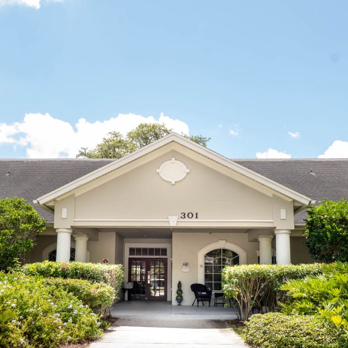 Front entrance with lush landscaping at The Club at Lake Wales in Lake Wales, Florida