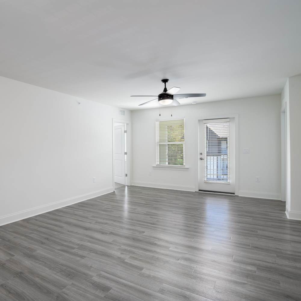 Unfurnished living room with wood-style flooring and a window at Retreat at Redstone in Crestview, Florida