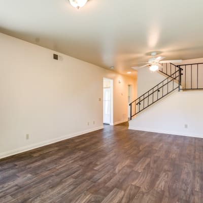 An open living room with wood flooring in a home at O'Neill Heights East in Oceanside, California