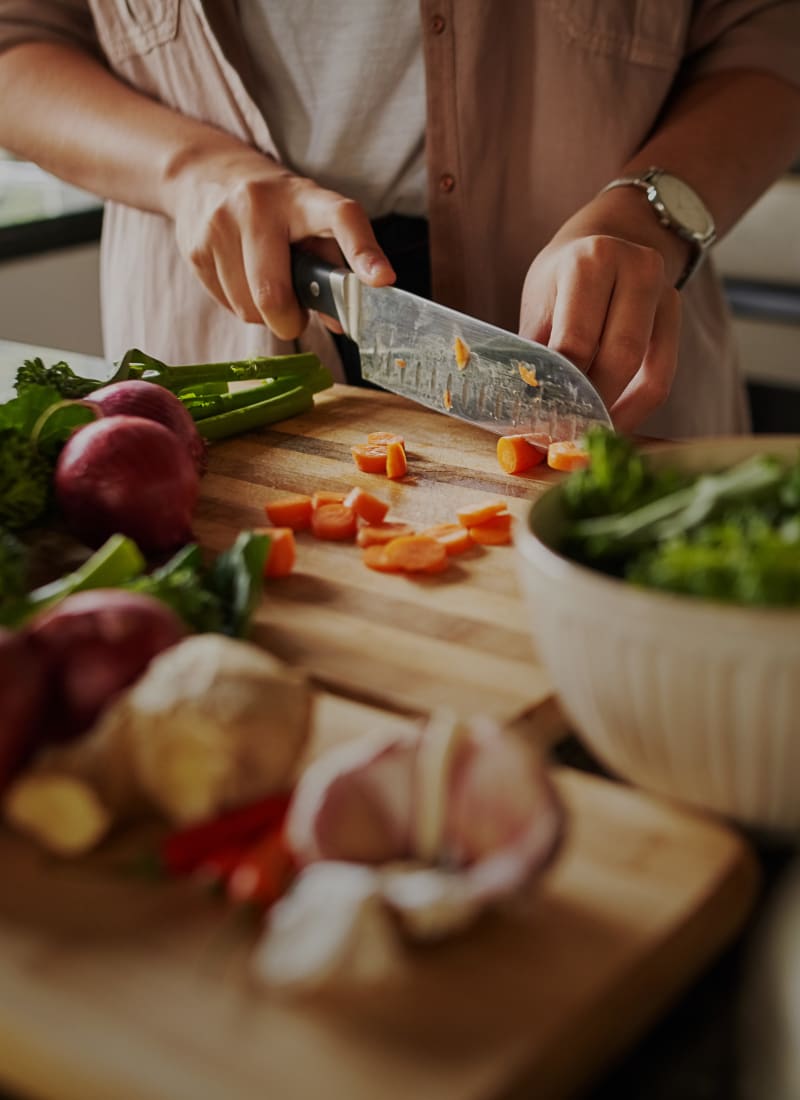 Resident cooking at Marquis Grand Lakes in Richmond, Texas