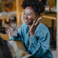 A woman holding a drink in her hand at Ravella at Town Center in Jacksonville, Florida