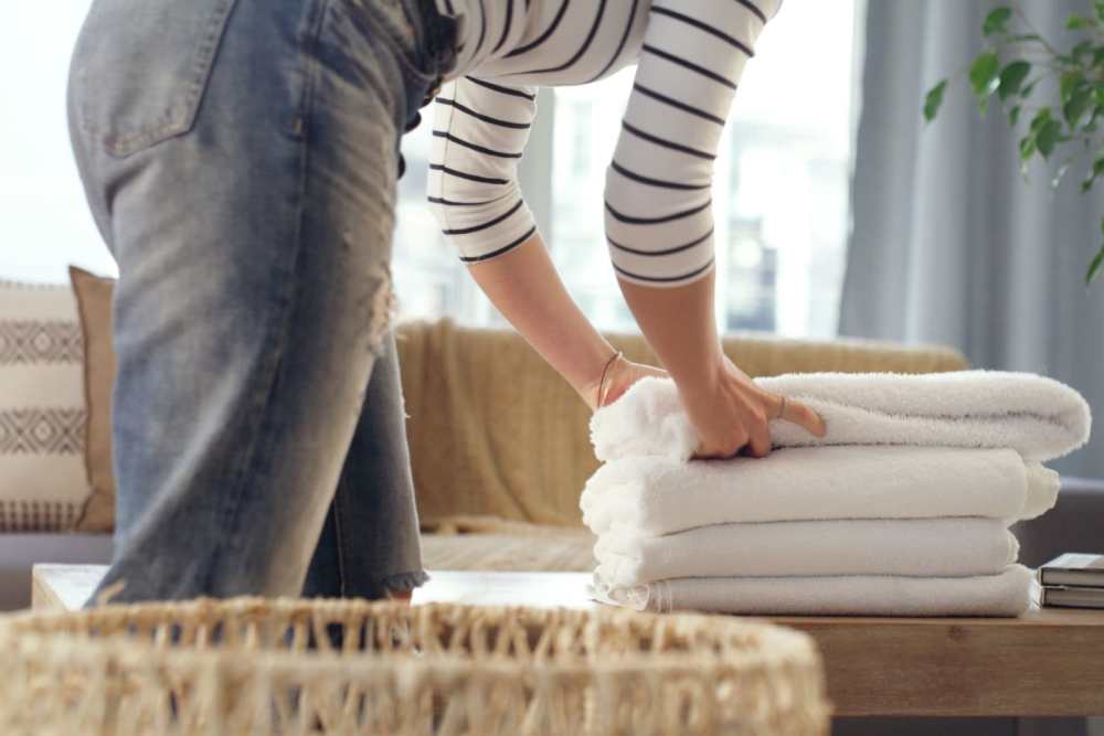 Woman folding laundry at Detroit Living in Detroit, Michigan
