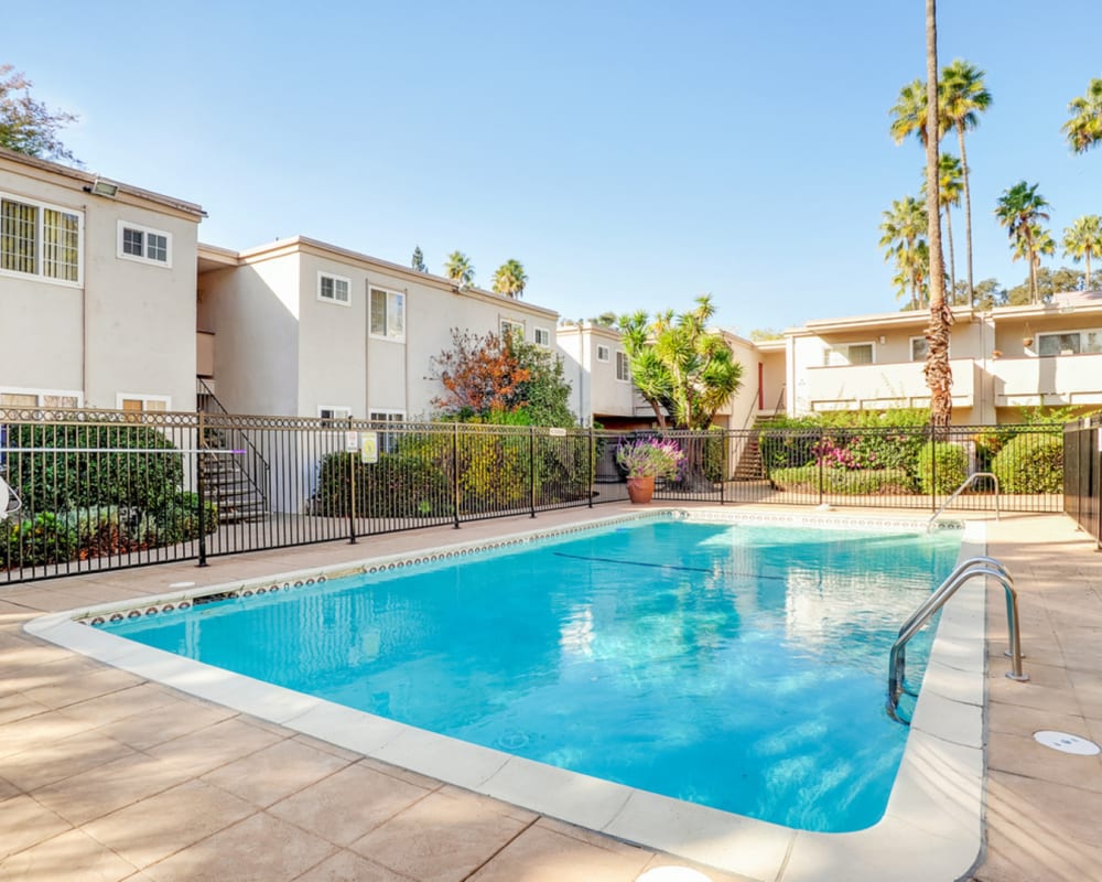Sparkling pool surrounded by security gate at Lakeshore Apartments in Concord, California