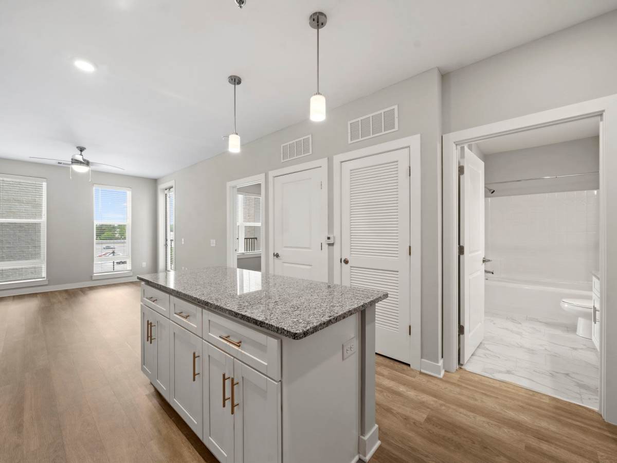 Island with granite countertop at The Rise at Regency in Henrico, Virginia