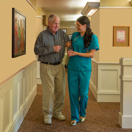 A nurse walking a resident down the hall at Carefield Castro Valley in Castro Valley, California.