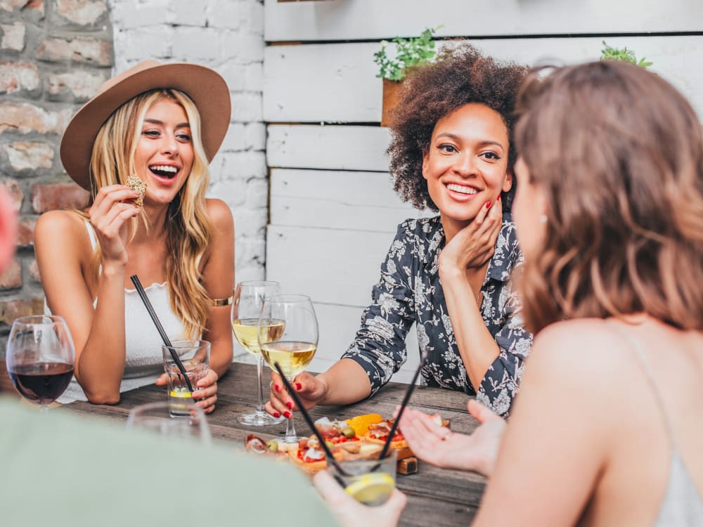 Resident friends enjoying drinks together at Harbor Point Apartments in Mill Valley, California