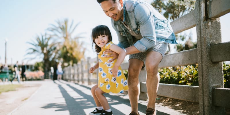 A father teaching his daughter how to skate near O'Neill Heights East in Oceanside, California
