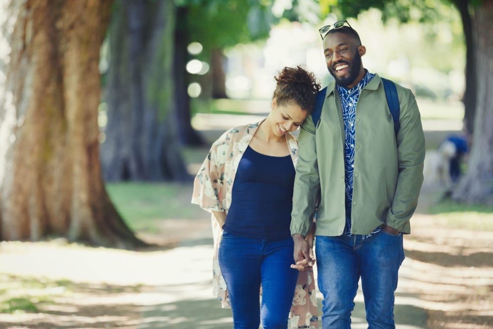 Couple walking through a park in Coppell, Texas near Oaks Riverchase