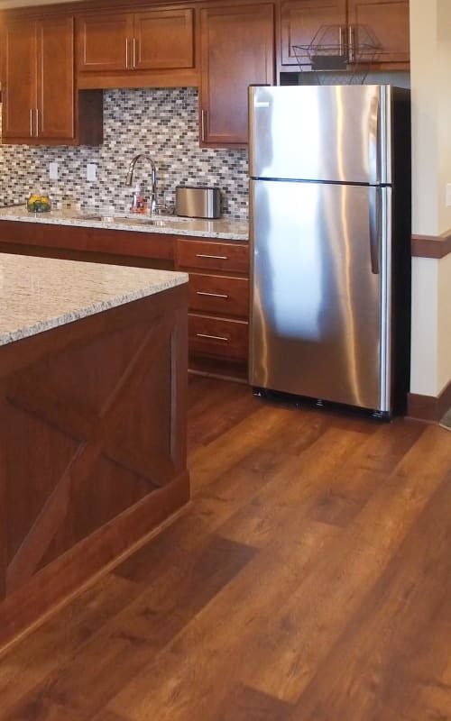 Resident community kitchen with stainless steel appliances at The Pillars of Mankato in Mankato, Minnesota