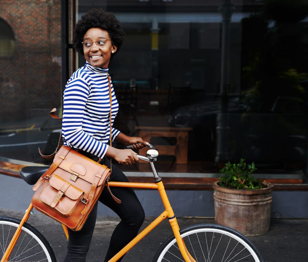 Resident riding her bike through the city near at The Marc, Palo Alto in Palo Alto, California