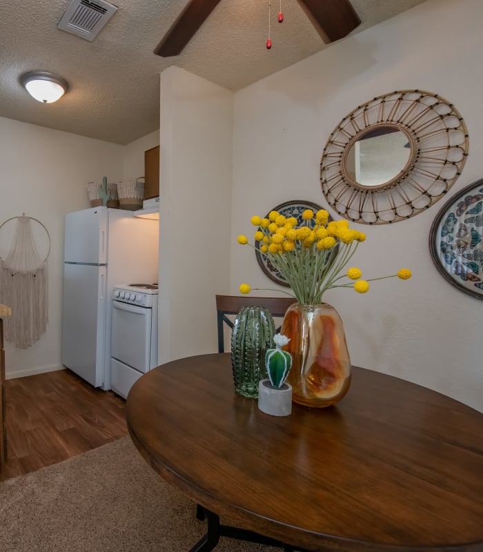Kitchen with dining room table and centerpiece at Aspen Park Apartments in Wichita, Kansas