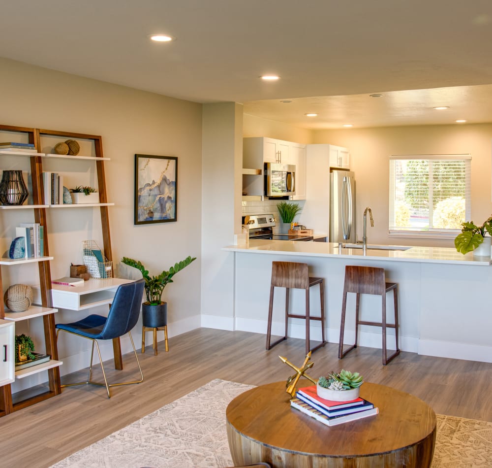 Open-concept layout with hardwood floors and modern decor in a model home at Harbor Point Apartments in Mill Valley, California