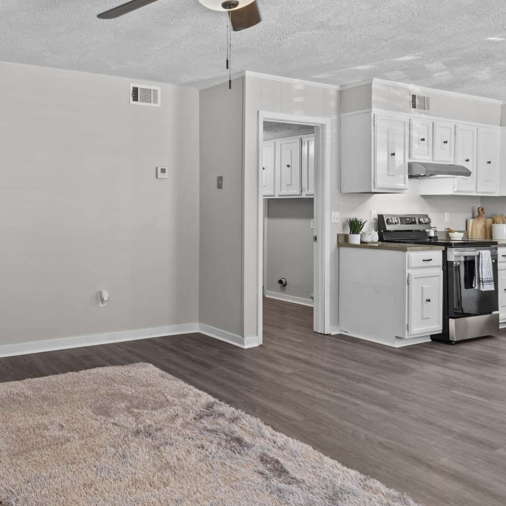 Spacious and modern kitchen opens to a bright living area with sleek finishes at Pecan Ridge in Vicksburg, Mississippi.