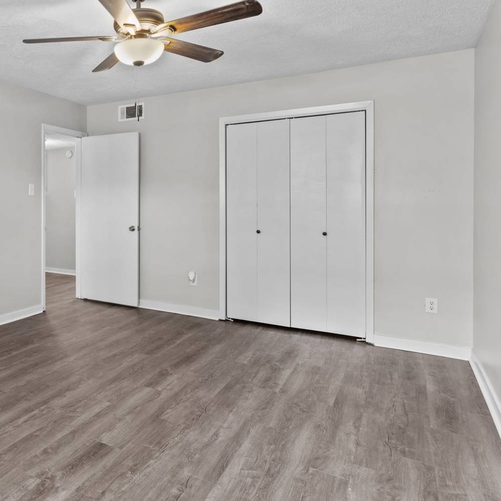 Charming bedroom with modern upgrades and beautifully designed flooring at Pecan Ridge in Vicksburg, Mississippi.