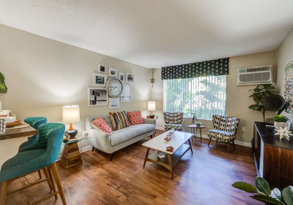 View of living room and dining room at UCE Apartment Homes in Fullerton, California, 