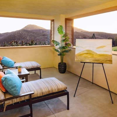 An open sun room with lounge chairs at Milestone Retirement Communities