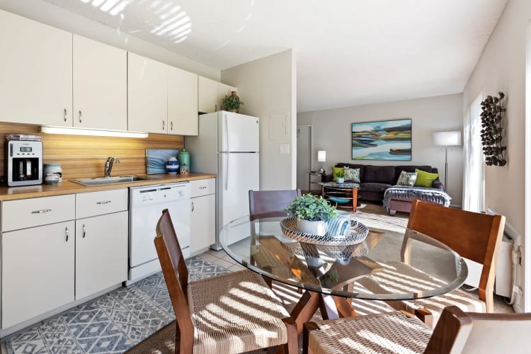 Dining area and fully equipped kitchen with tons of natural light in a studio apartment at Executive Apartments in Miami Lakes, Florida