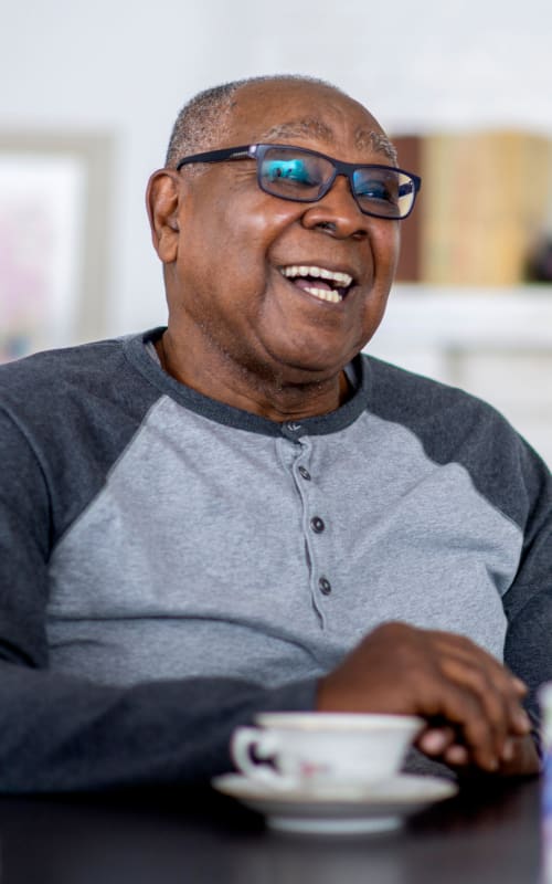 A resident enjoying a cup of coffee at Jaybird Senior Living