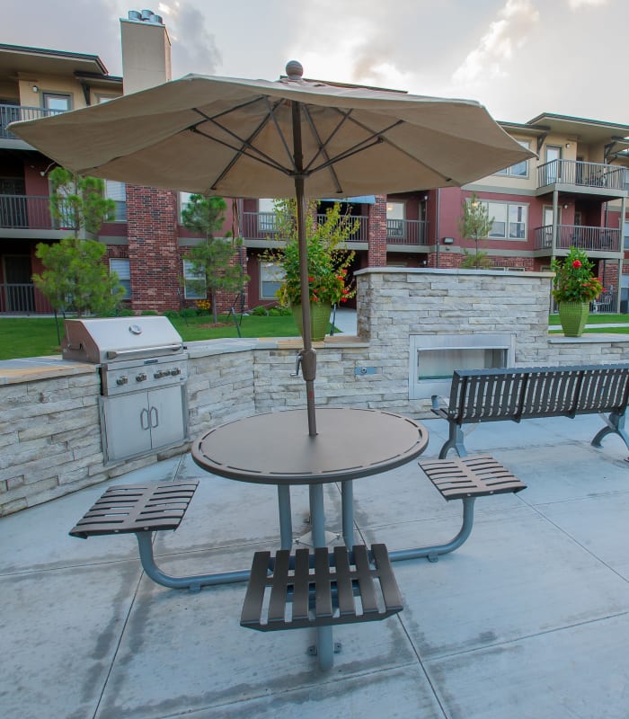 Umbrella seating with bbq grill of The Reserve at Elm in Jenks, Oklahoma