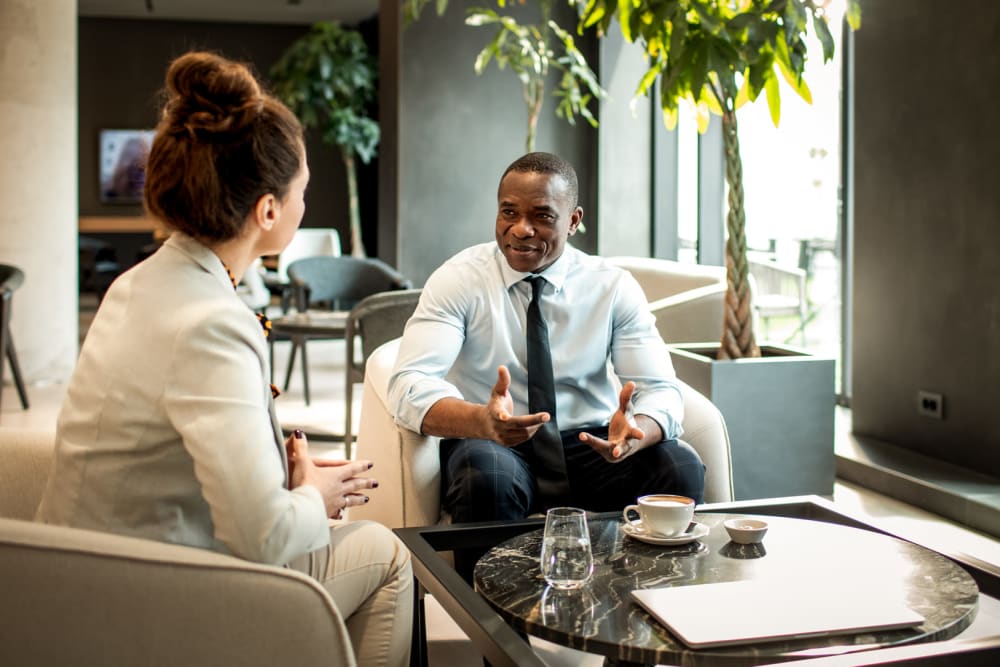 Two people discussing investment opportunities at Ridgeline Management Company in Rockwall, Texas