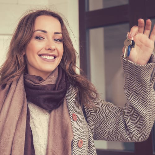 a resident holding her keys to her home at Davis Hill in Joint Base Lewis McChord, Washington