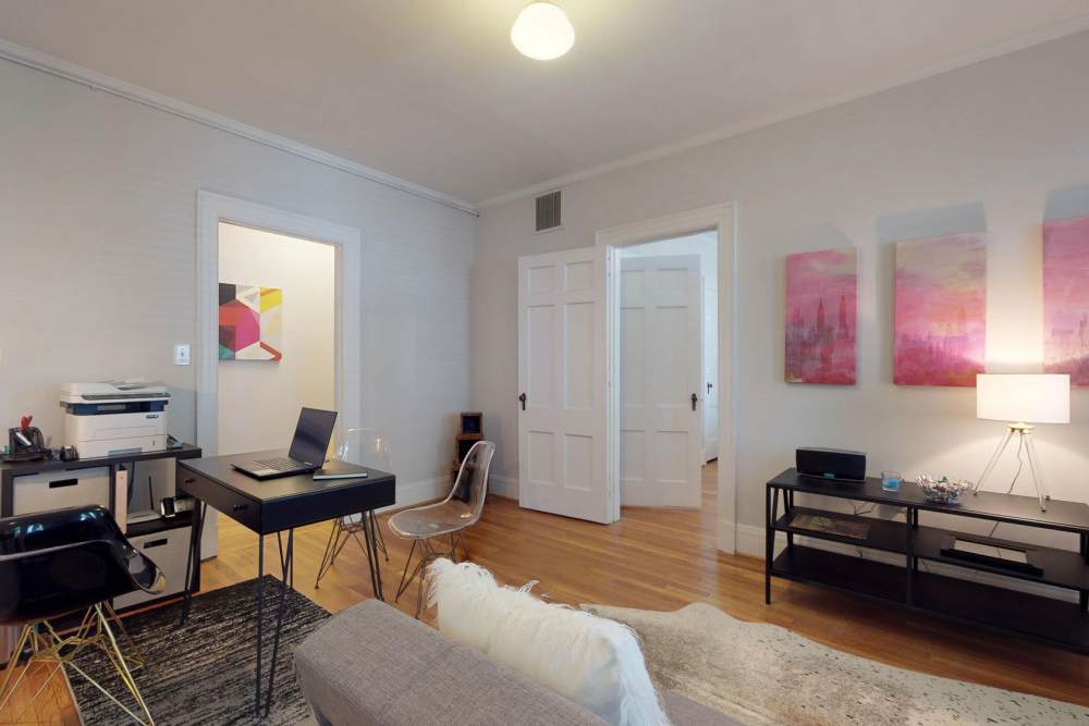Living room with couch and laptop space at Historic Boylan Apartments in Raleigh, North Carolina