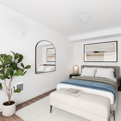 Model bedroom with lively indoor plant at Allegro in Lynnwood, Washington