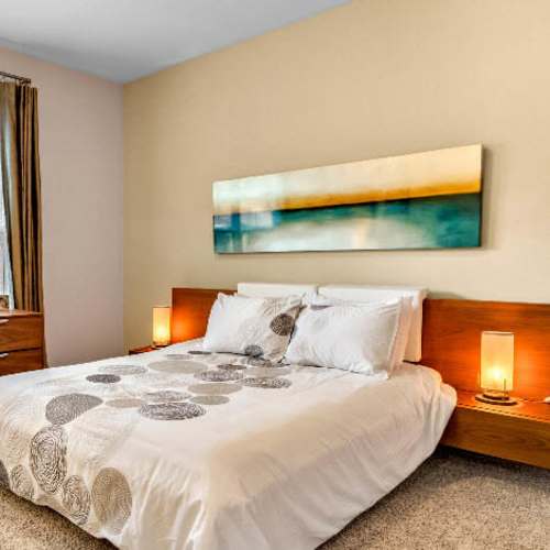 Comfortably furnished bedroom in a model home at Bridford West in Greensboro, North Carolina