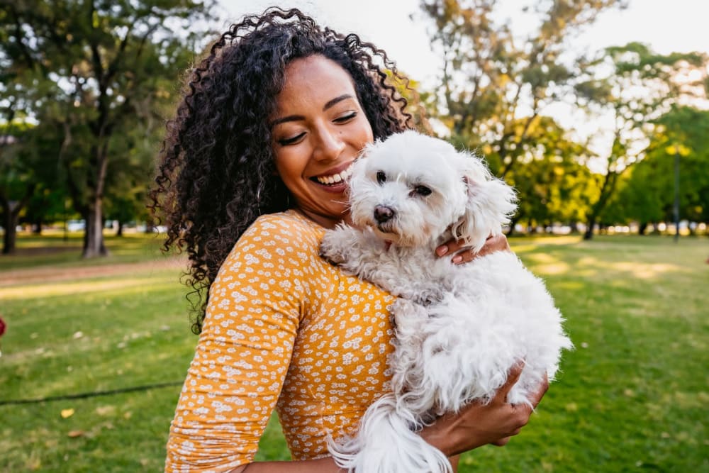 Resident holding her dog at a park near Muirwood Gardens in Martinez, California