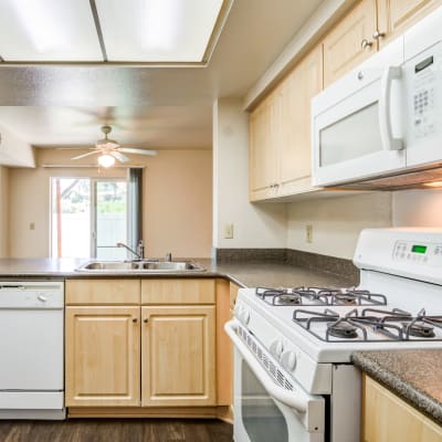 A kitchen with appliances in a home at O'Neill Heights East in Oceanside, California