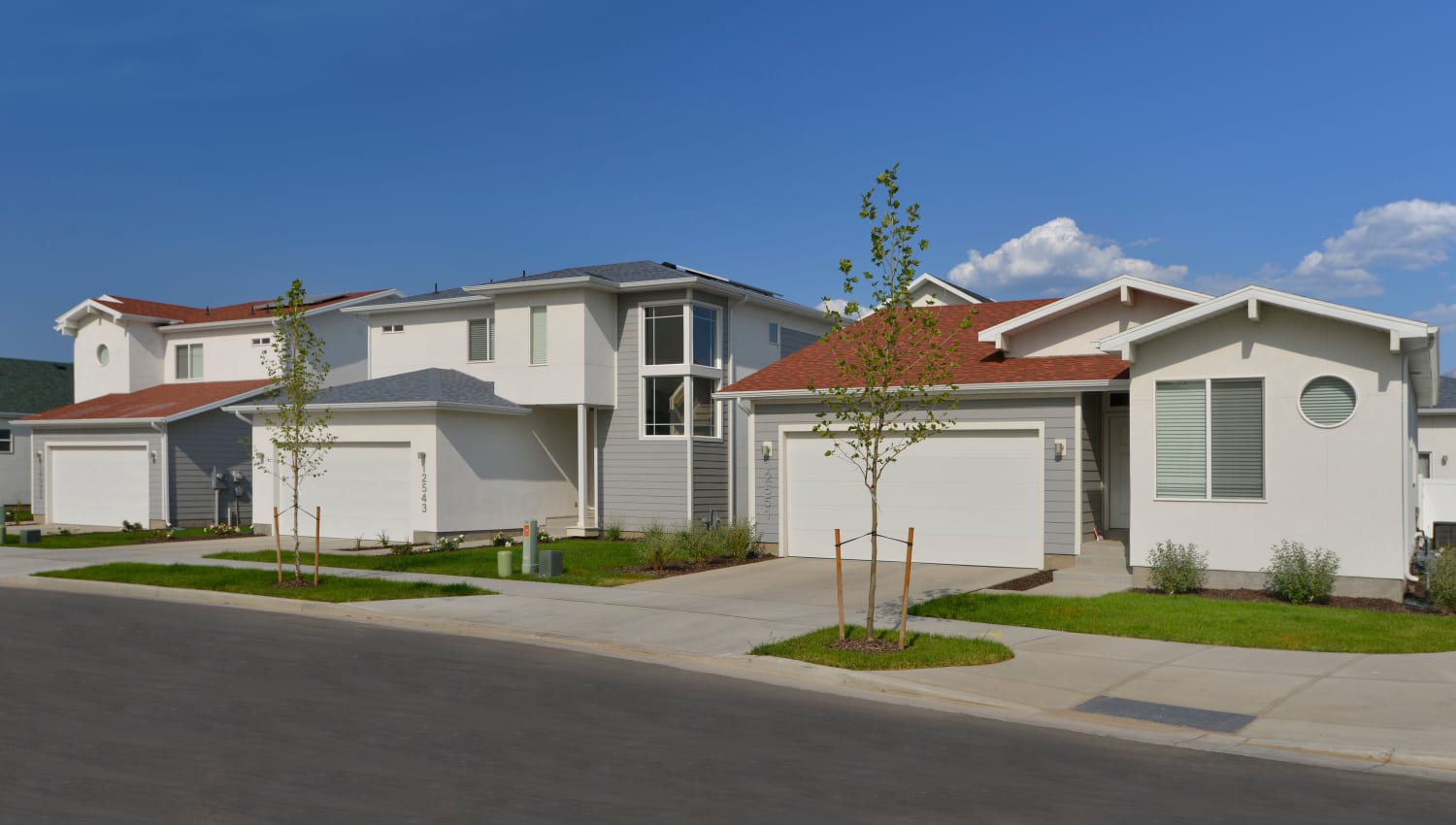 Beautifully landscaped community with sidewalks at Olympus at the Canyons in Herriman, Utah