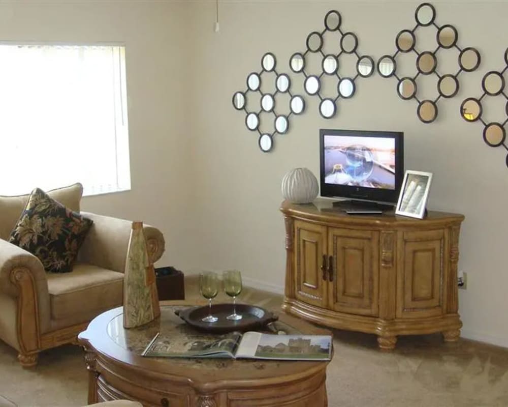 Living room with mirrored wall art at Mission Bay in Rockledge, Florida