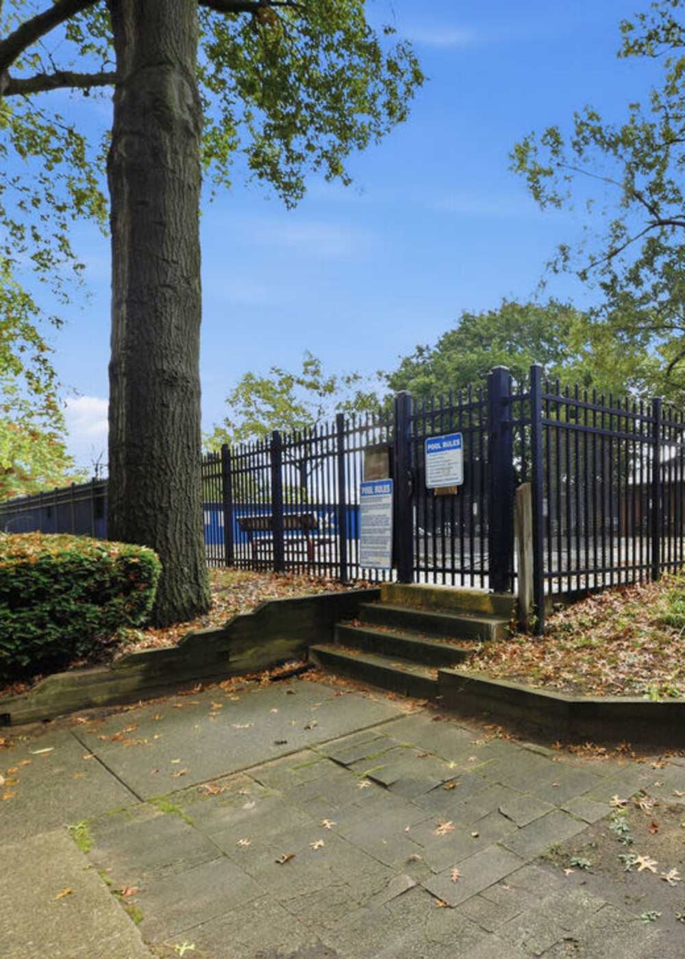 Charming pool area surrounded by lush landscaping at The Reserve at Pin Oak Manor Apartments in Mishawaka, Indiana.