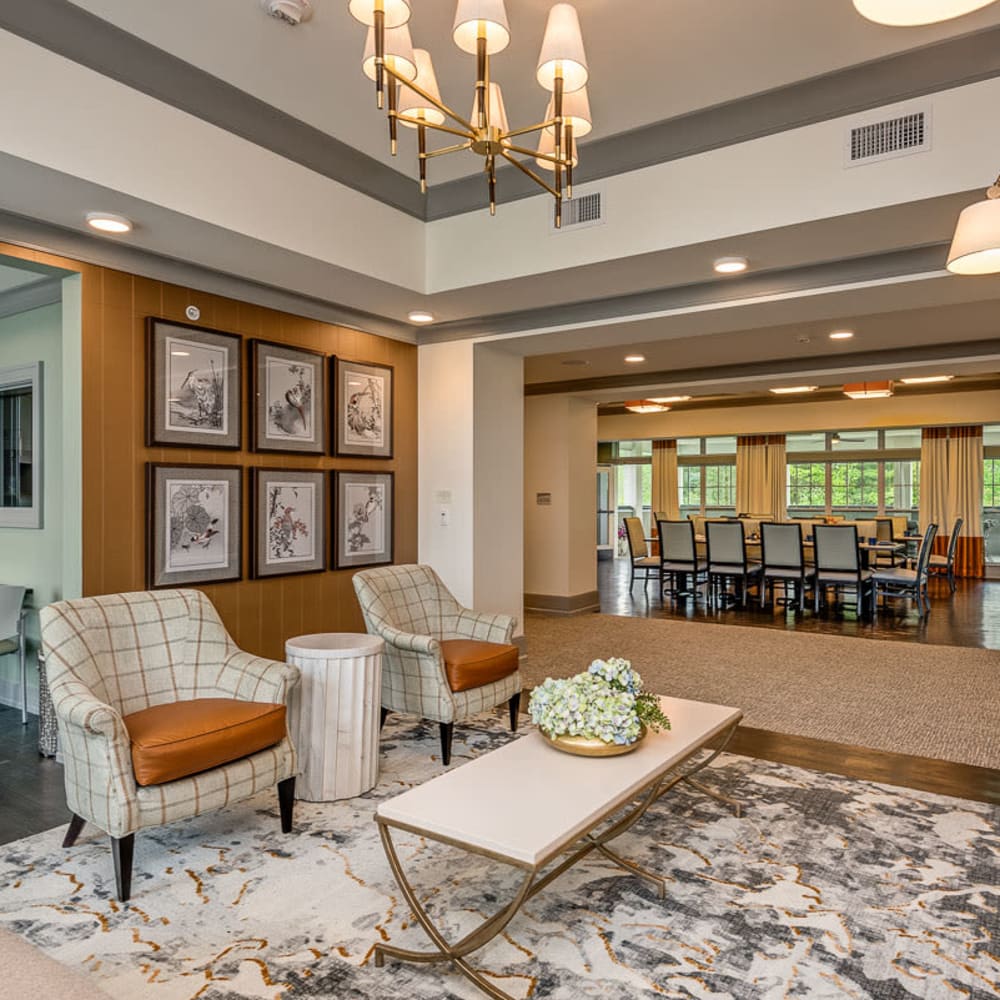 Lounge area with a dining room visible in the background at Anthology of Wildwood in Wildwood, Missouri