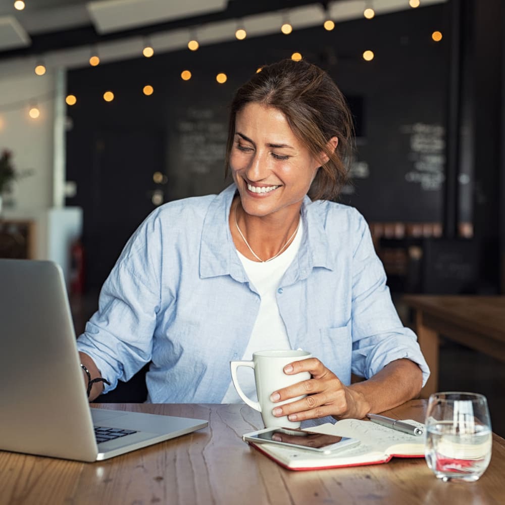 Resident getting some work on her laptop at a café near Oaks Hiawatha Station in Minneapolis, Minnesota