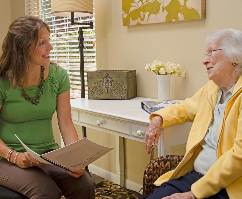 A resident talking to a staff member at Carefield Living.