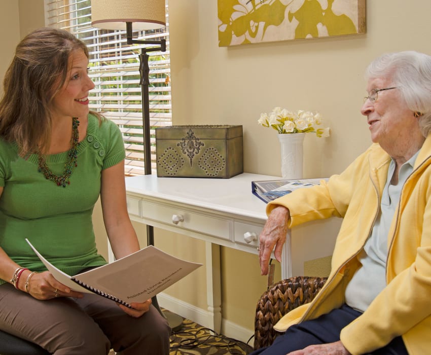 A resident talking to a staff member at Carefield Living. 