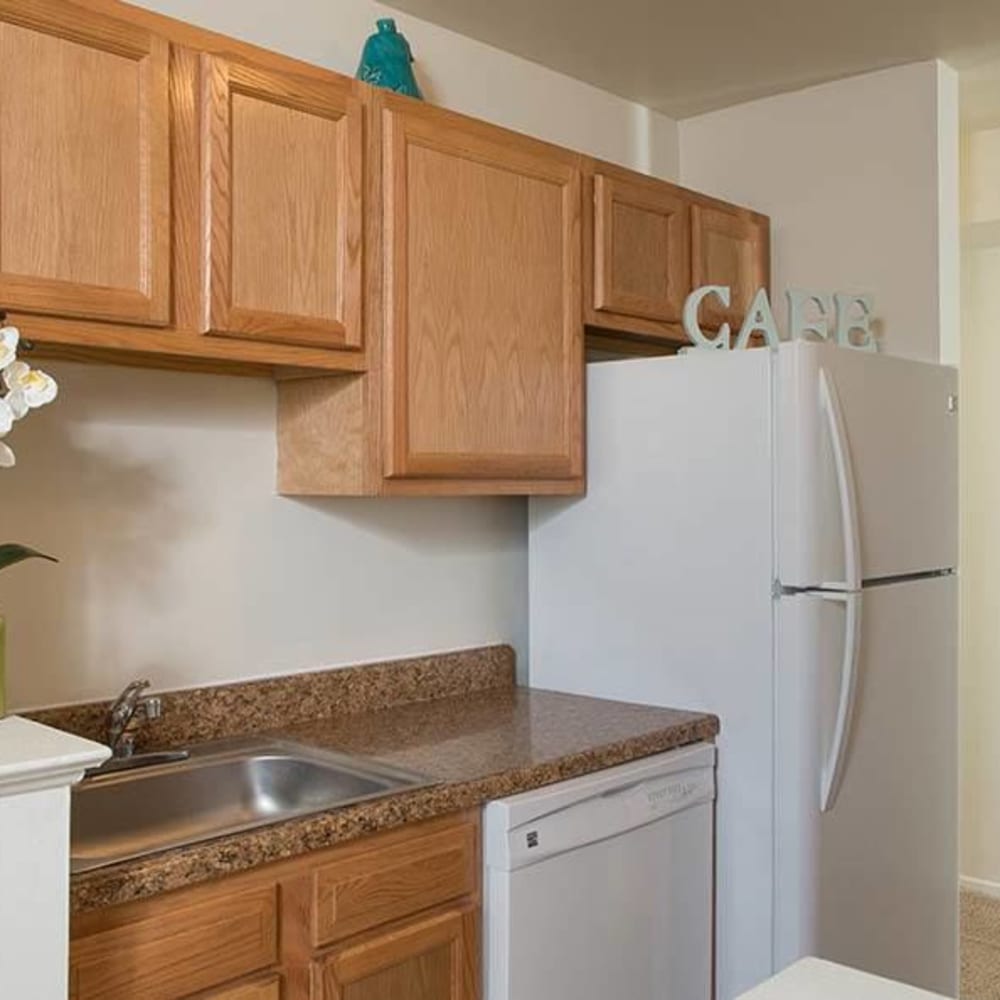 Kitchen with white appliances in a home at Hillcrest Village in Niskayuna, New York