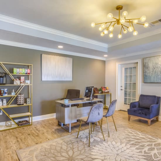 Resident lounge with a fireplace and flatscreen TV at Northbrook & Pinebrook in Ridgeland, Mississippi