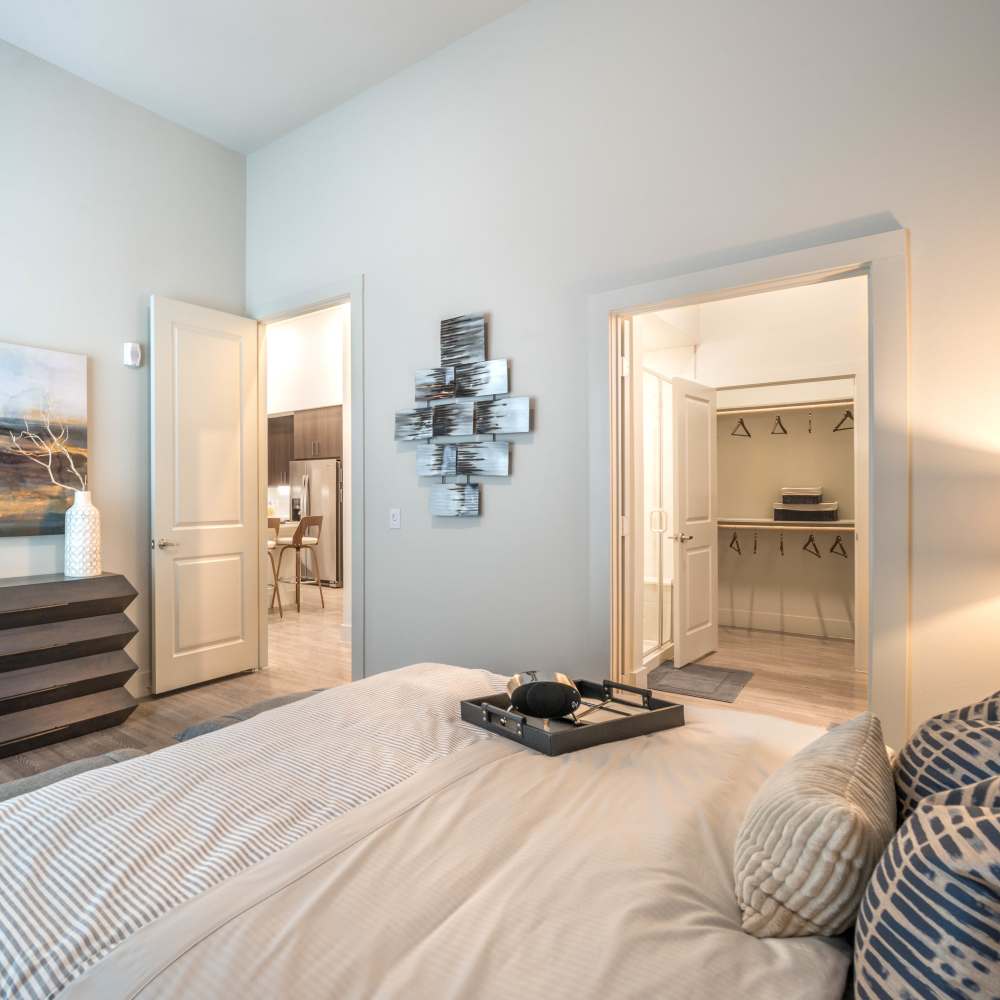 Well-furnished bedroom in the apartment with walk-in closet at Hall Street Flats in Dallas, Texas