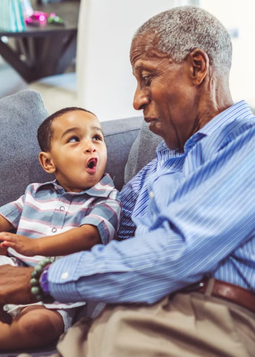 Resident reading a book with their grandchild at Liberty Arms Assisted Living in Youngstown, Ohio