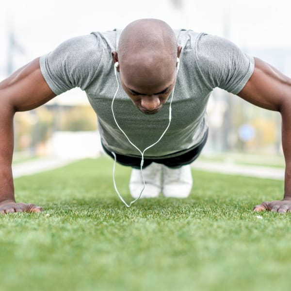 Resident doing some pushups at a sports field near Olympus Sierra Pines in The Woodlands, Texas 