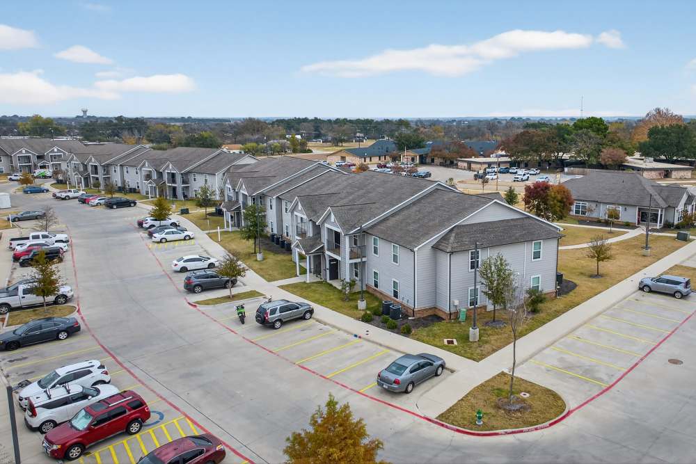 Charming community setting with modern multi-family homes and lush landscaping at Lakewood Crossing in Granbury, Texas.