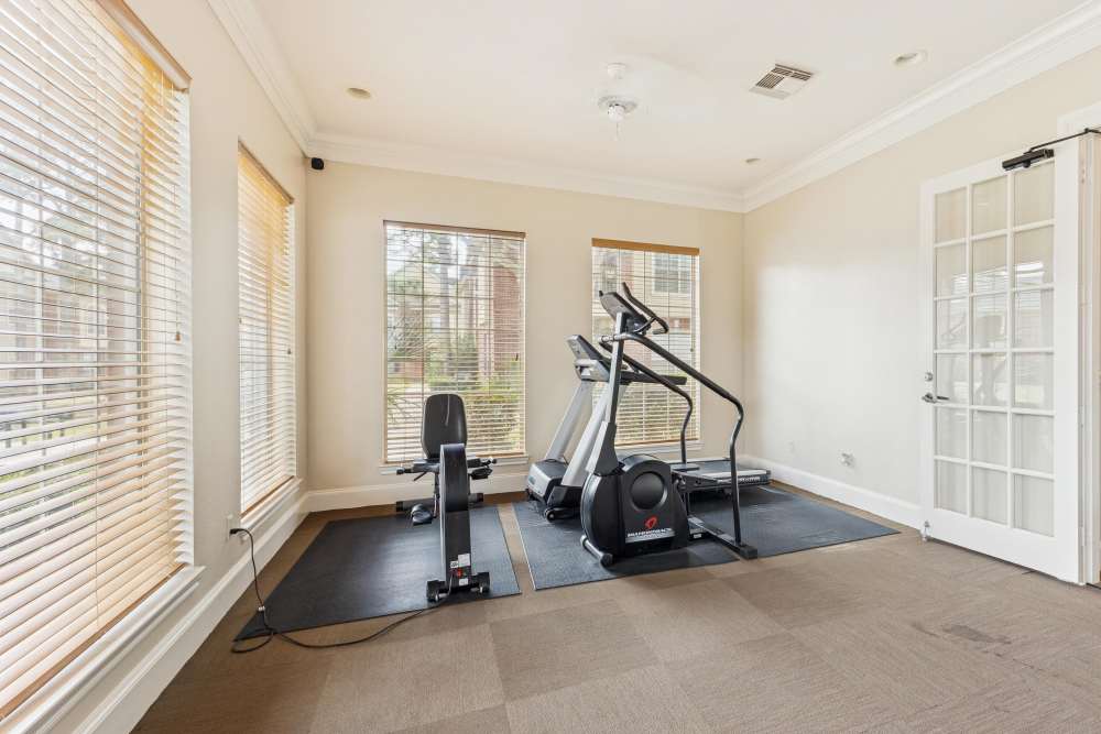 Fitness center with tread mills at Brazoswood Apartments in Clute, Texas