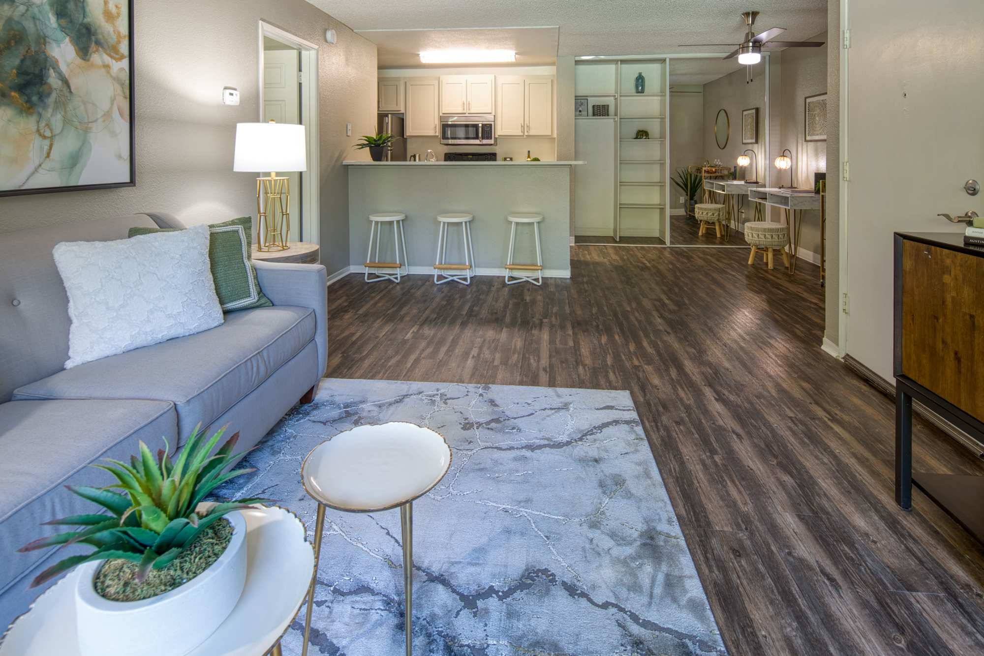 Living room with view to kitchen at Falls at Arden in Sacramento, California