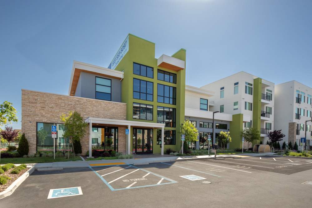 Exterior view of the community with parking spaces at Zeta Luxury Apartments in Sacramento, California